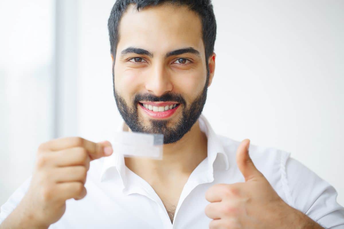 Teeth,Whitening.,Beautiful,Smiling,Woman,Holding,Whitening,Strip.,High,Resolution How to Make Your Teeth Whiter